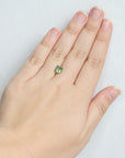 Green emerald cut sapphire on hand 