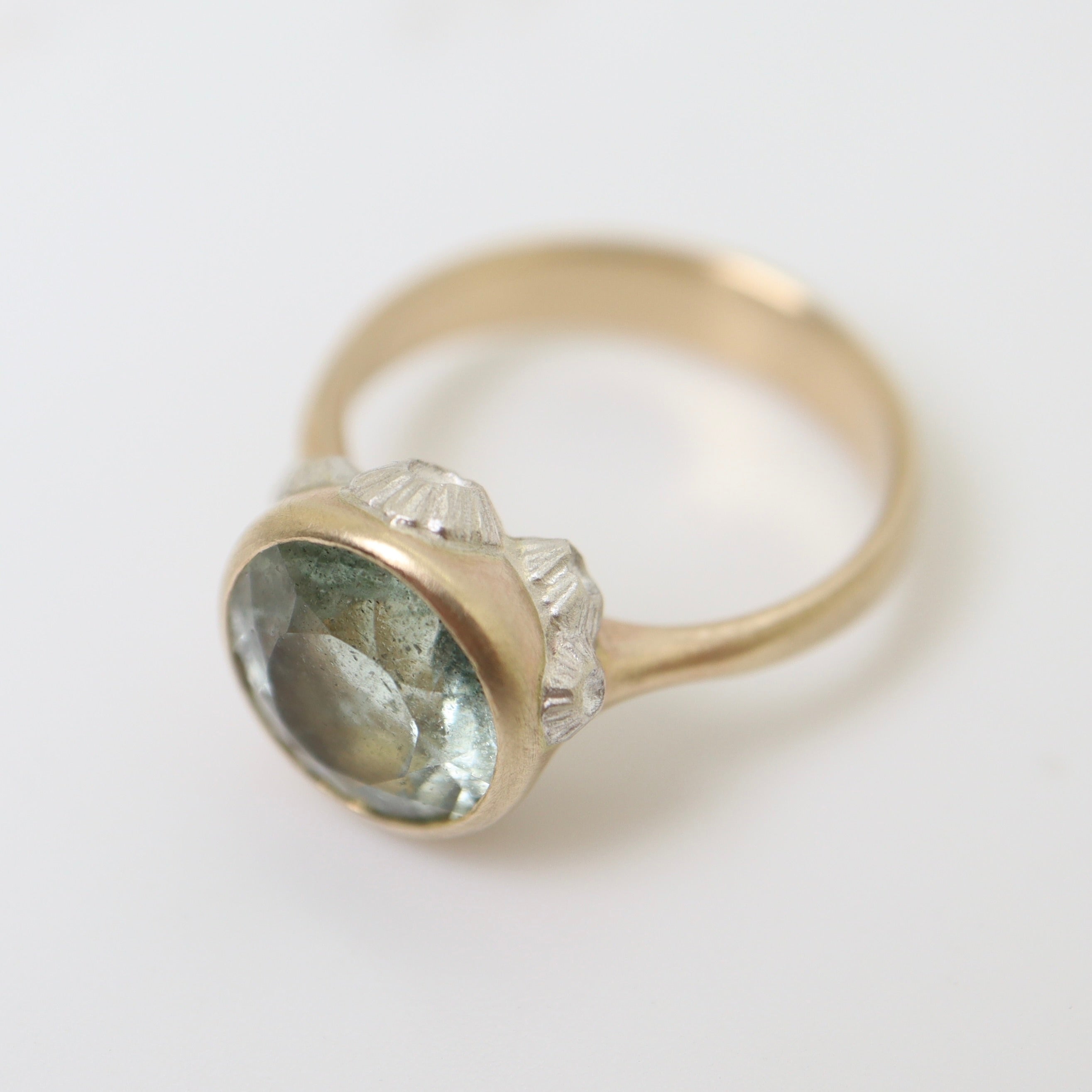 watery moss aquamarine ring set in gold with silver barnacles