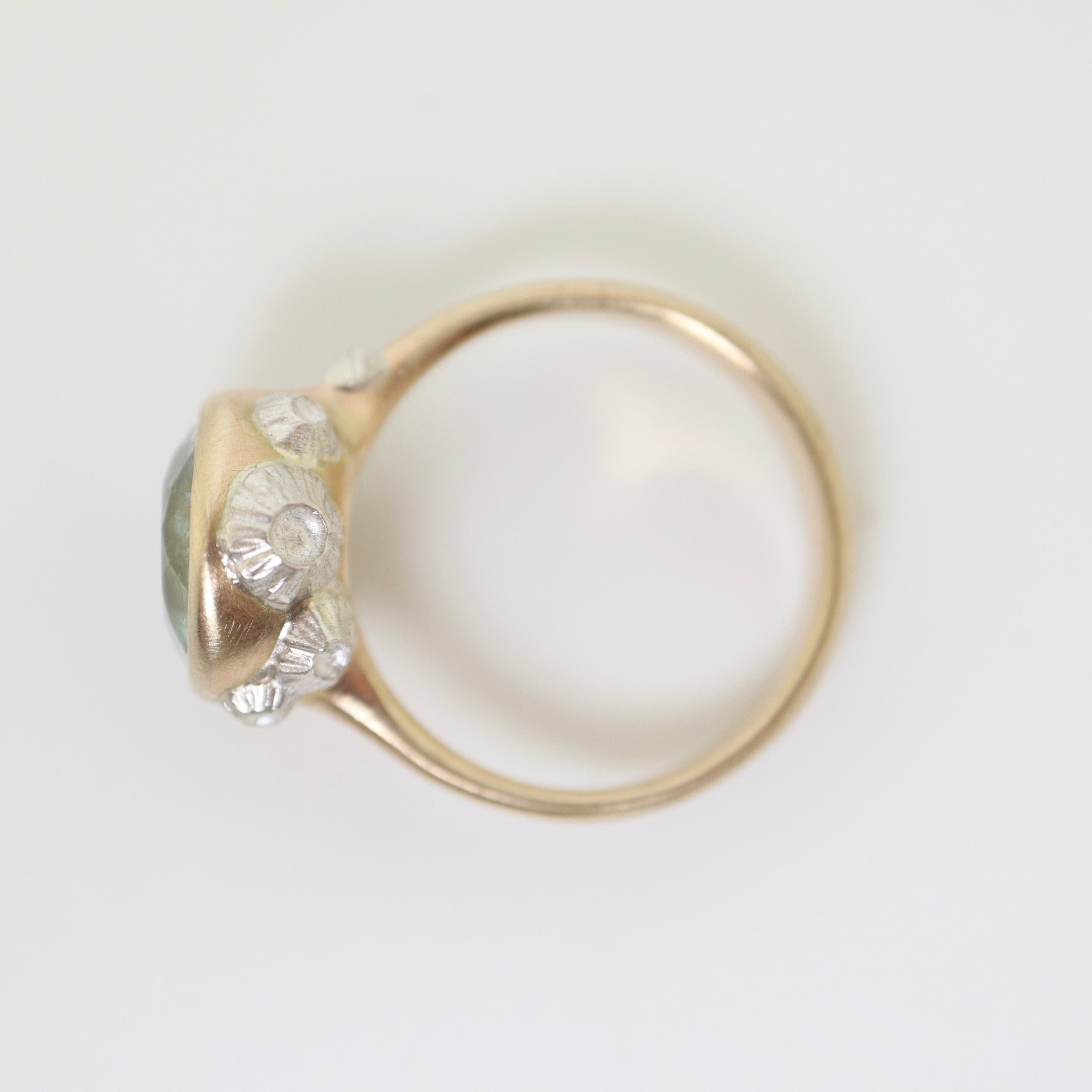 watery moss aquamarine ring set in gold with silver barnacles- side view