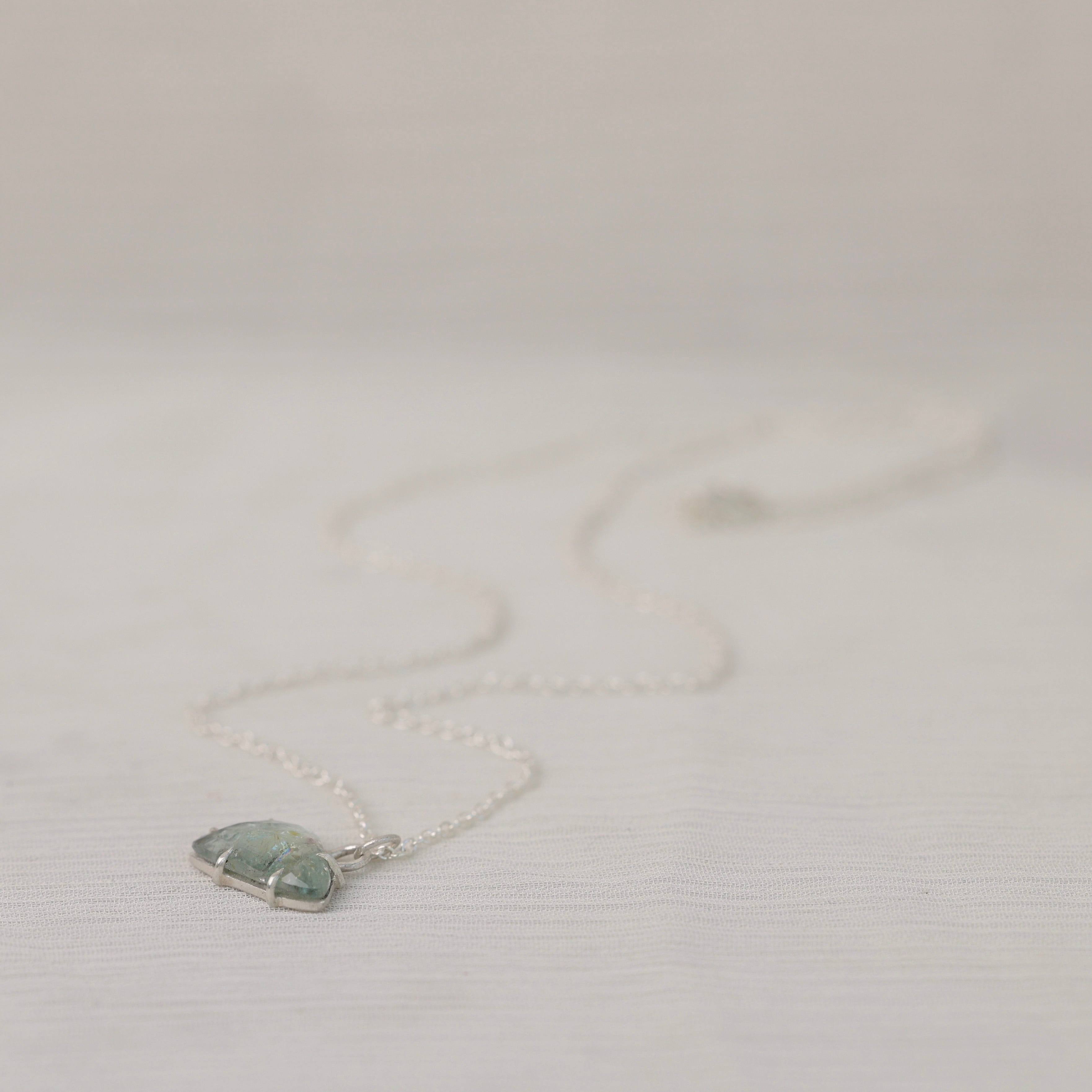 Necklace with a pendant on a light gray background