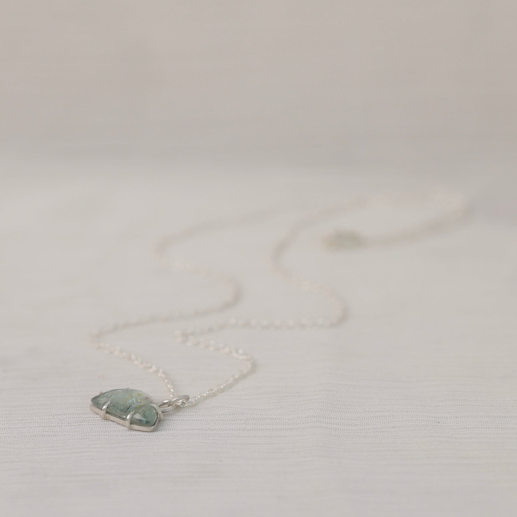 Necklace with a pendant on a light gray background