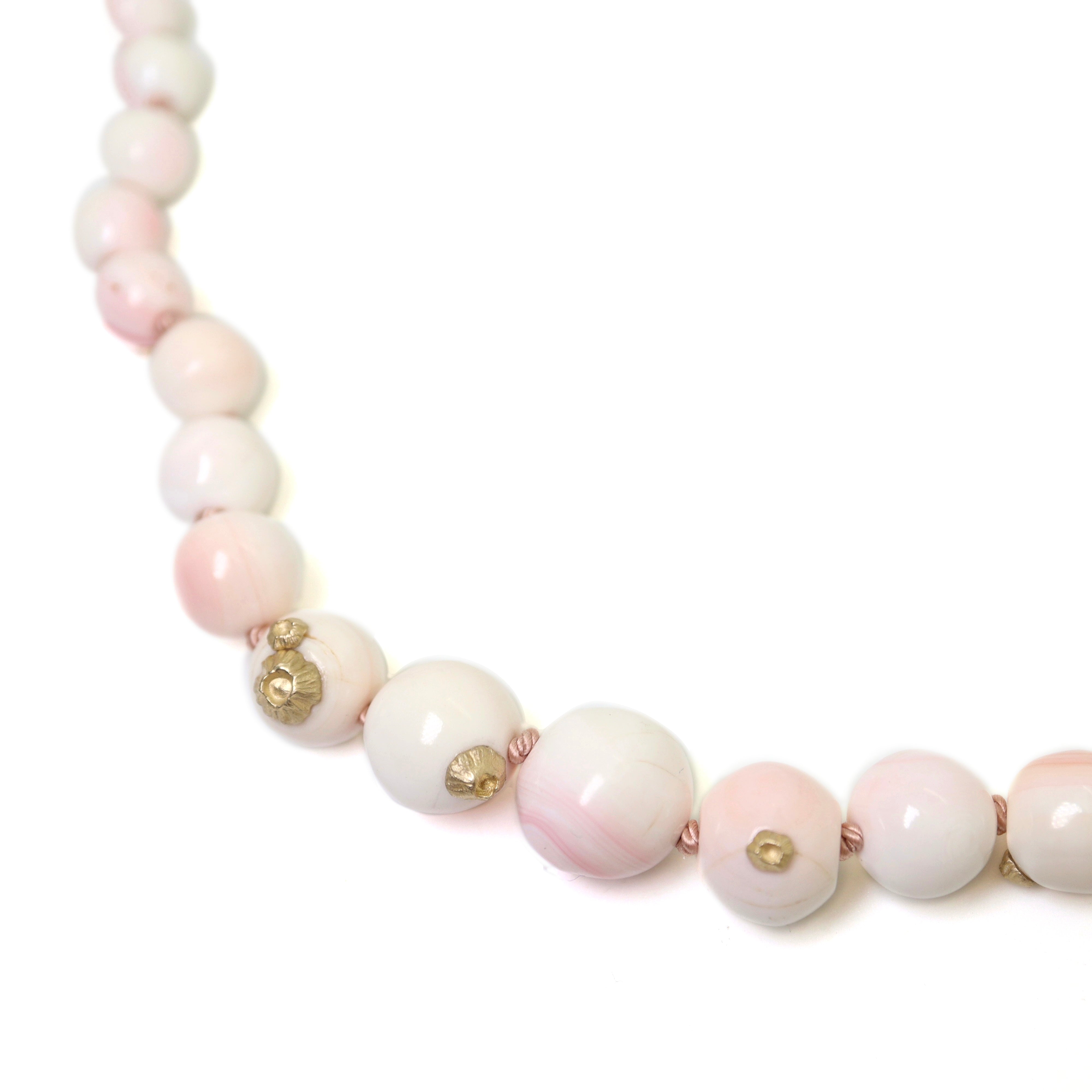 vintage angel skin coral beads are white and pink with yellow gold barnacles and pink silk