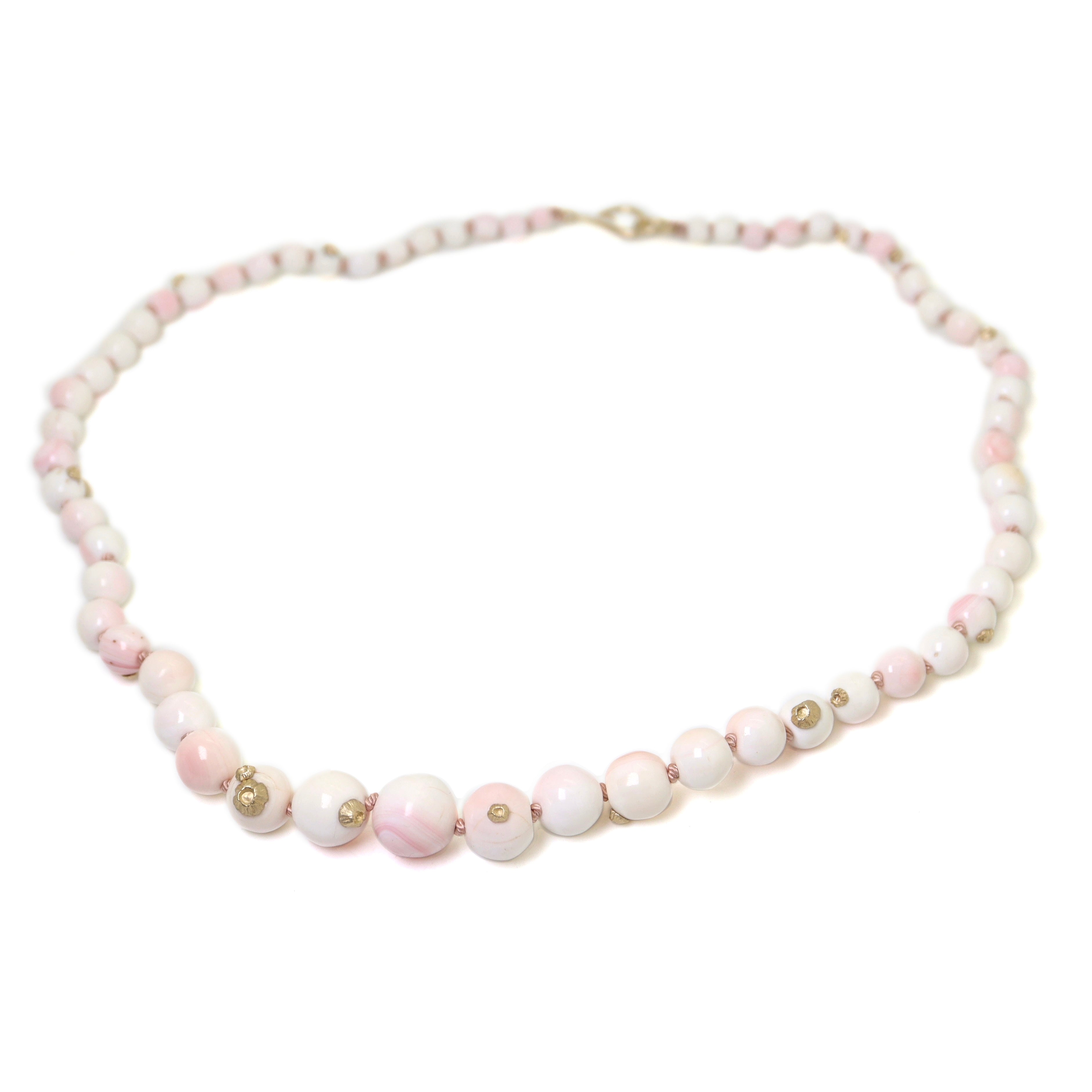 vintage angel skin coral beads are white and pink with yellow gold barnacles and pink silk