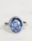 Silver ring with a blue gemstone on a white background