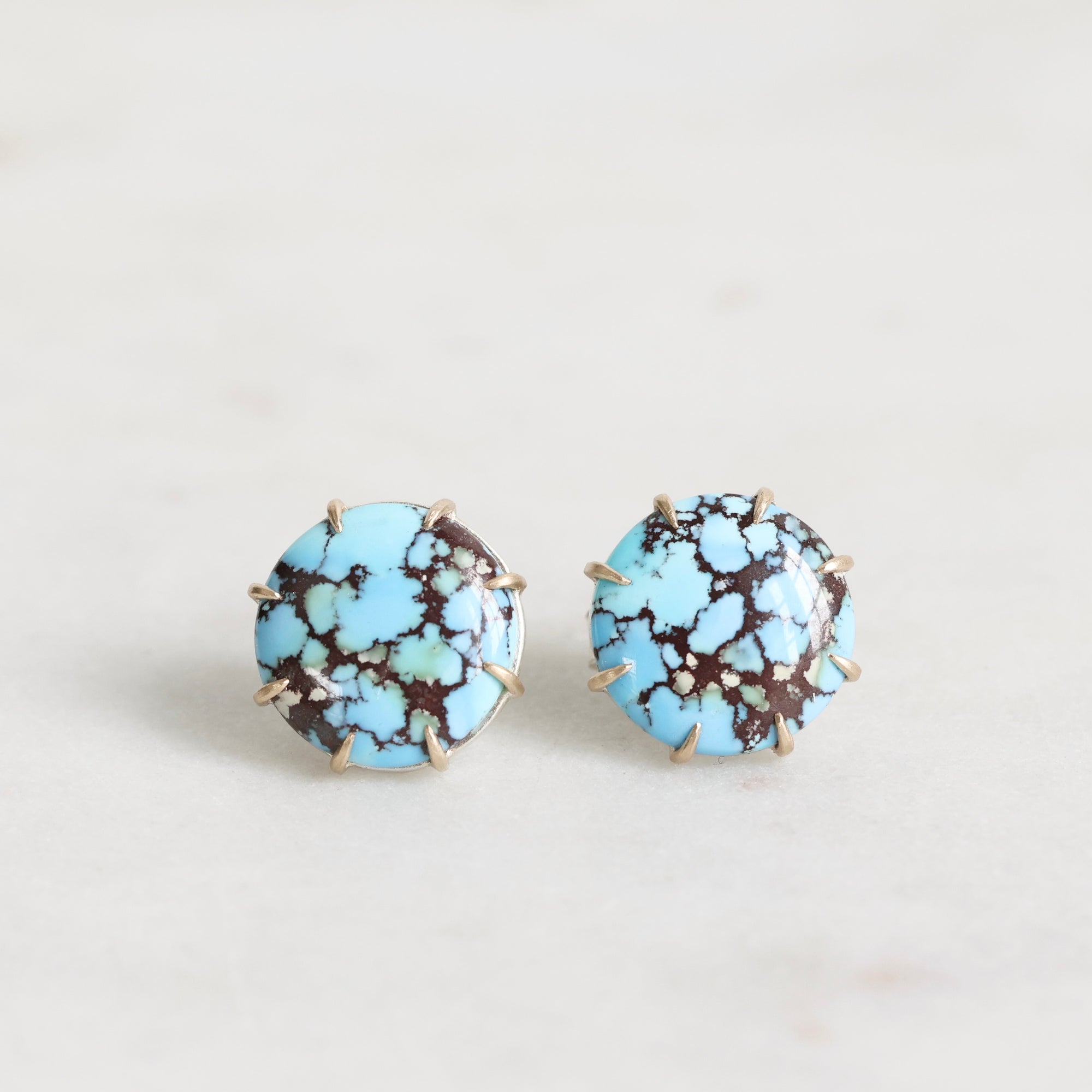 Turquoise stone earrings on a light gray background