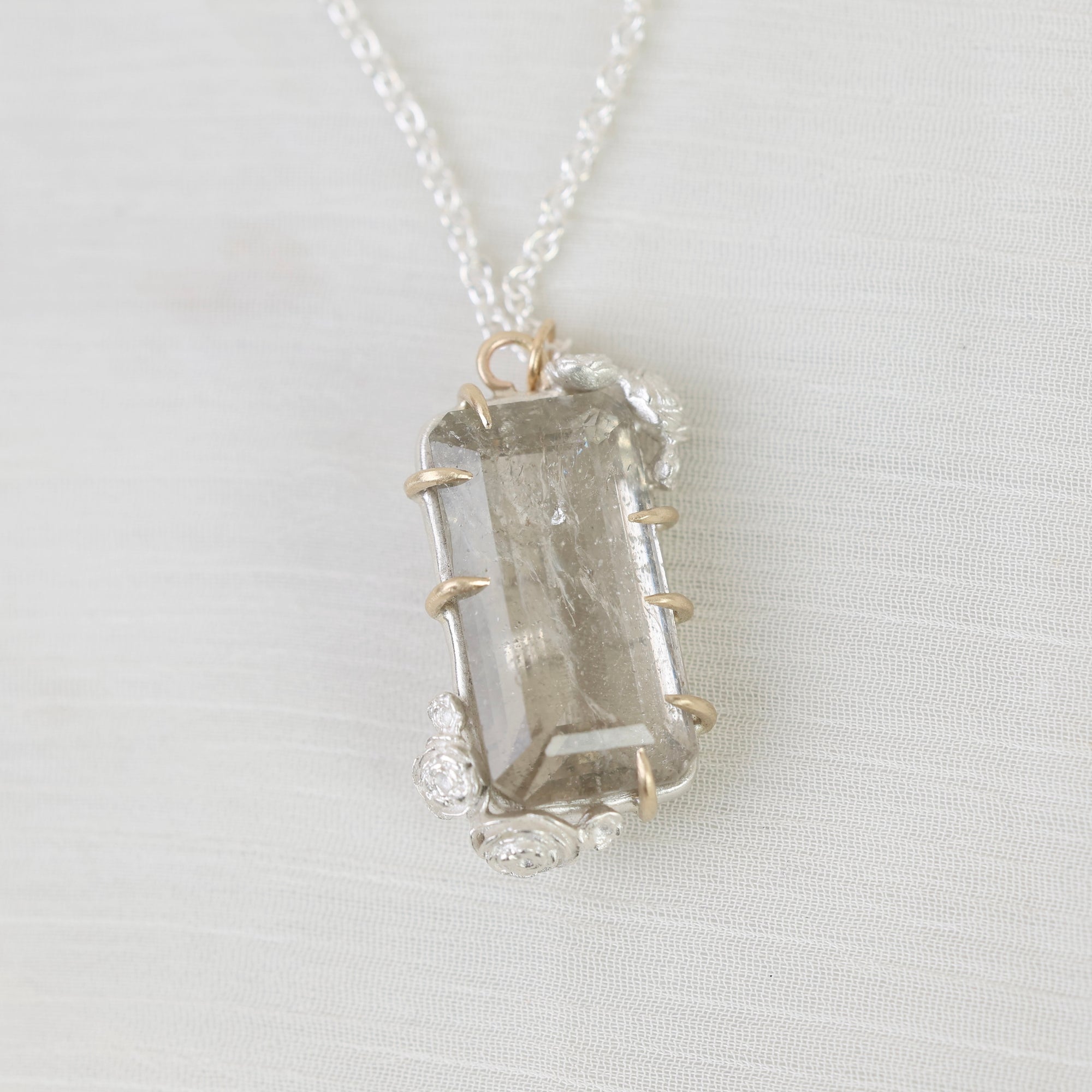 Necklace with a light gemstone pendant on a white background