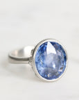 Silver ring with a blue gemstone on a white background
