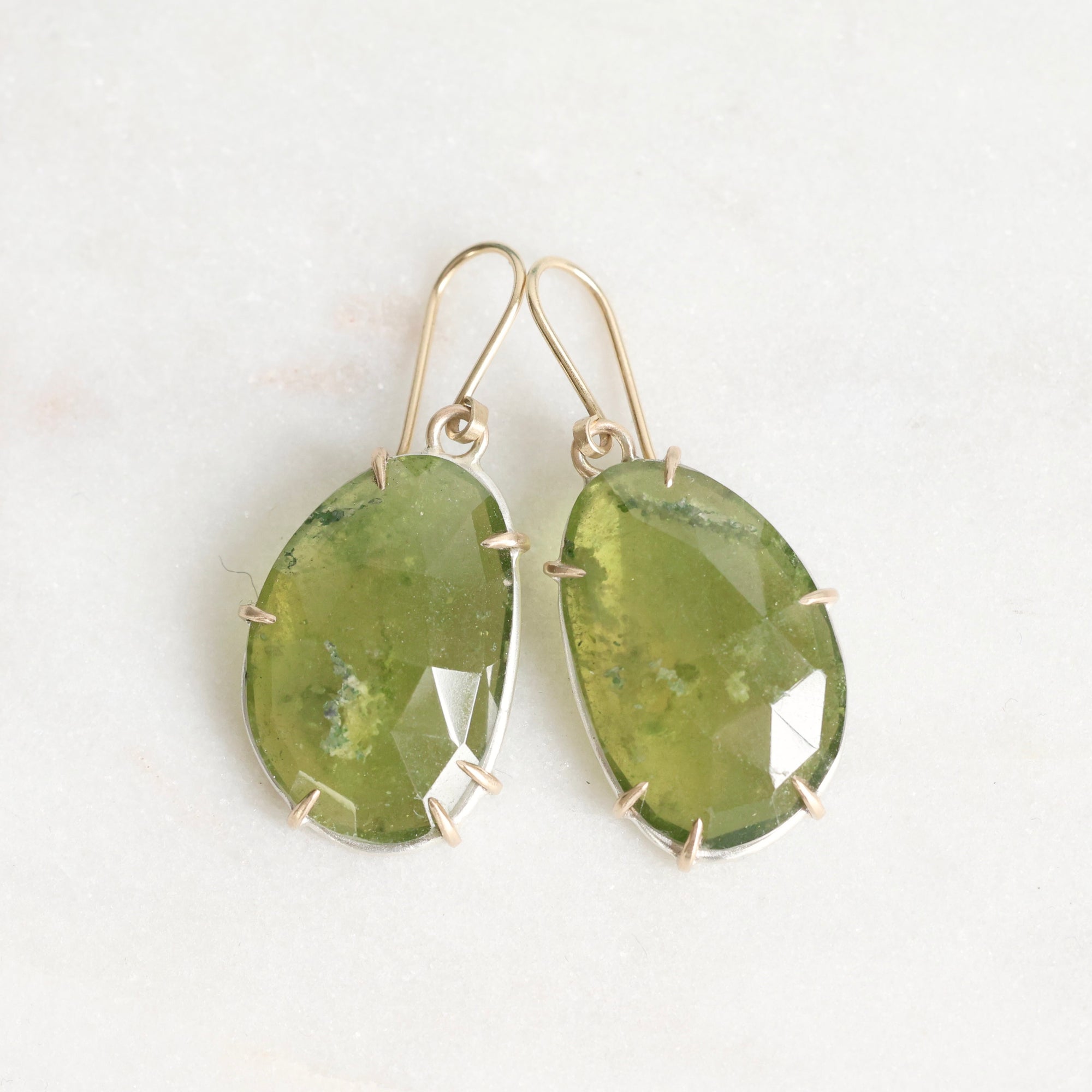 Green stone earrings on a white background