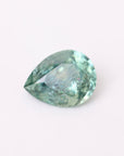 Greenish-blue gemstone on a white background