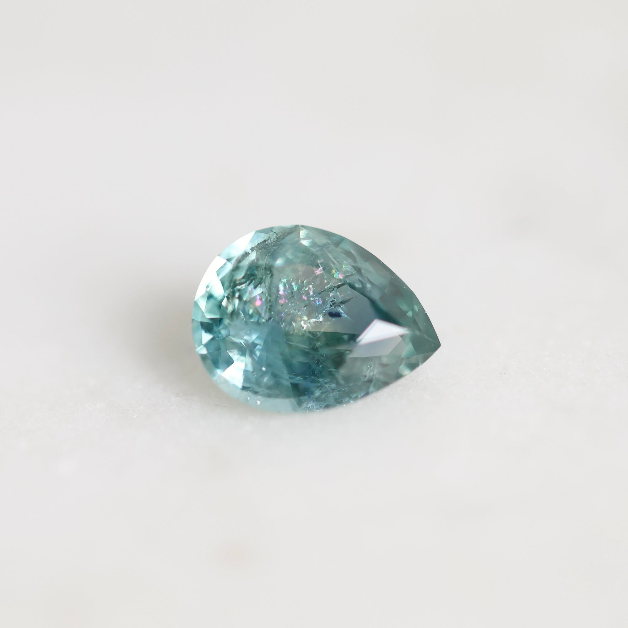 Blue/green Montana sapphire pear shaped with rainbow inclusion