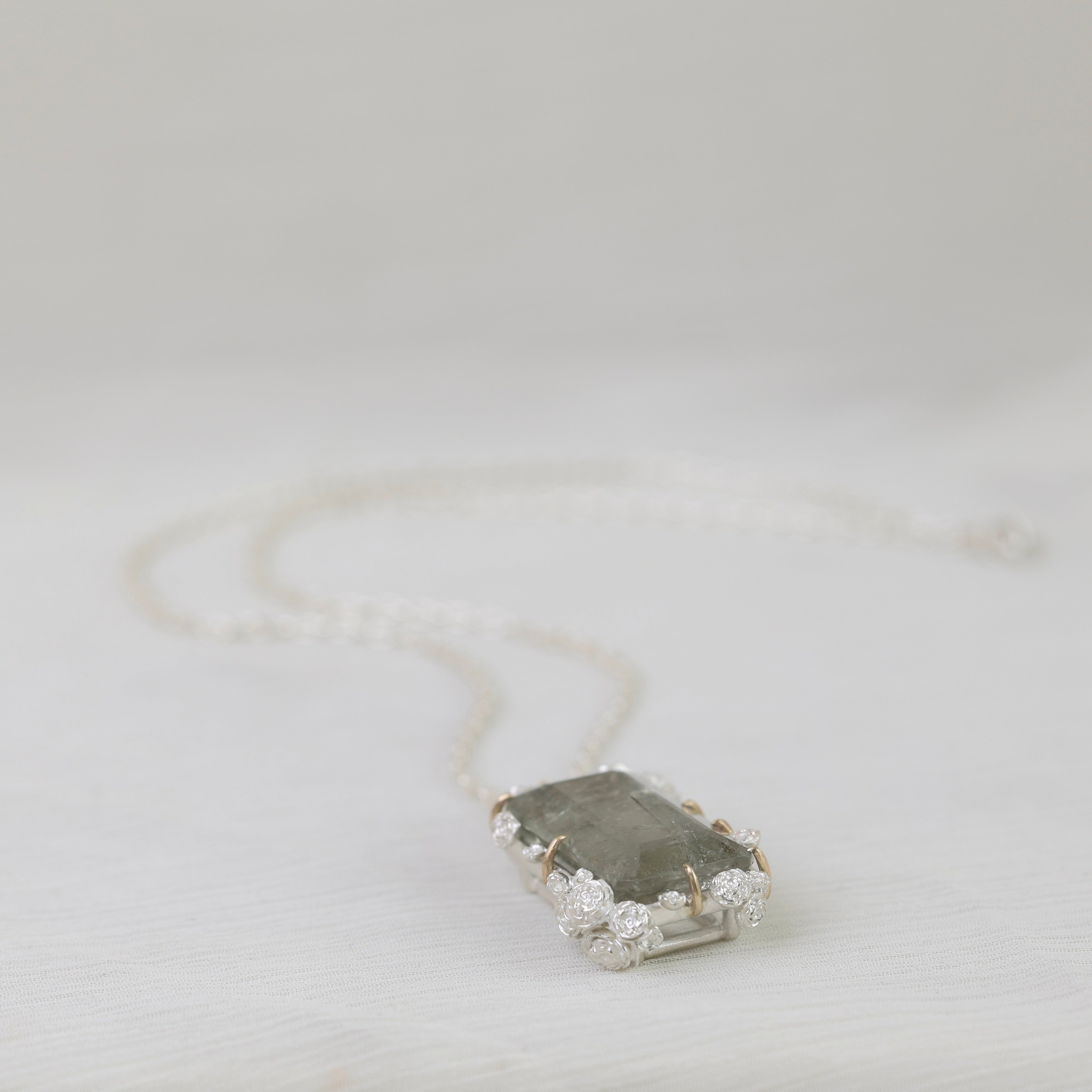 Necklace with a pendant on a light gray background