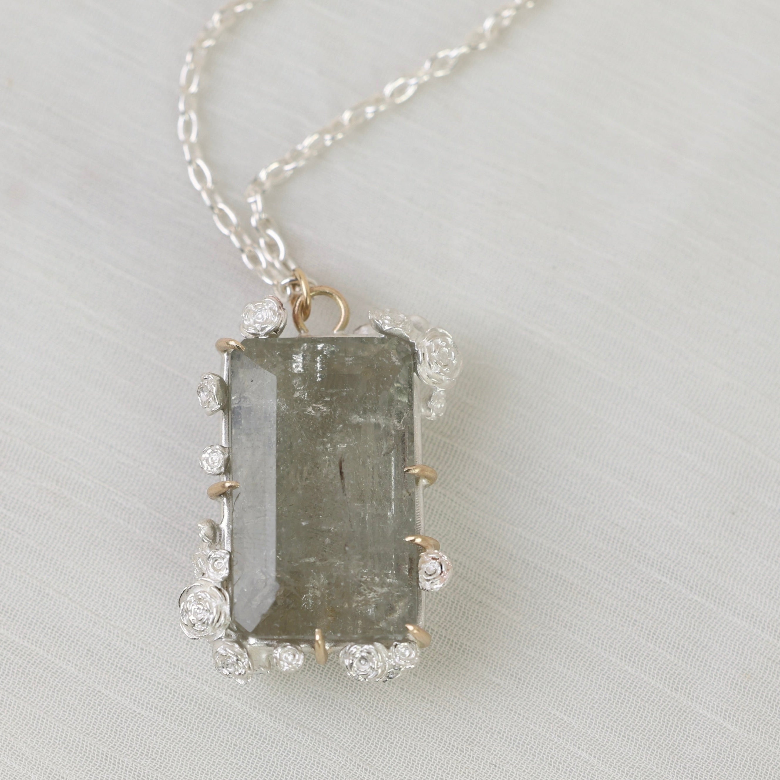 Necklace with a rectangular pendant on a light gray background