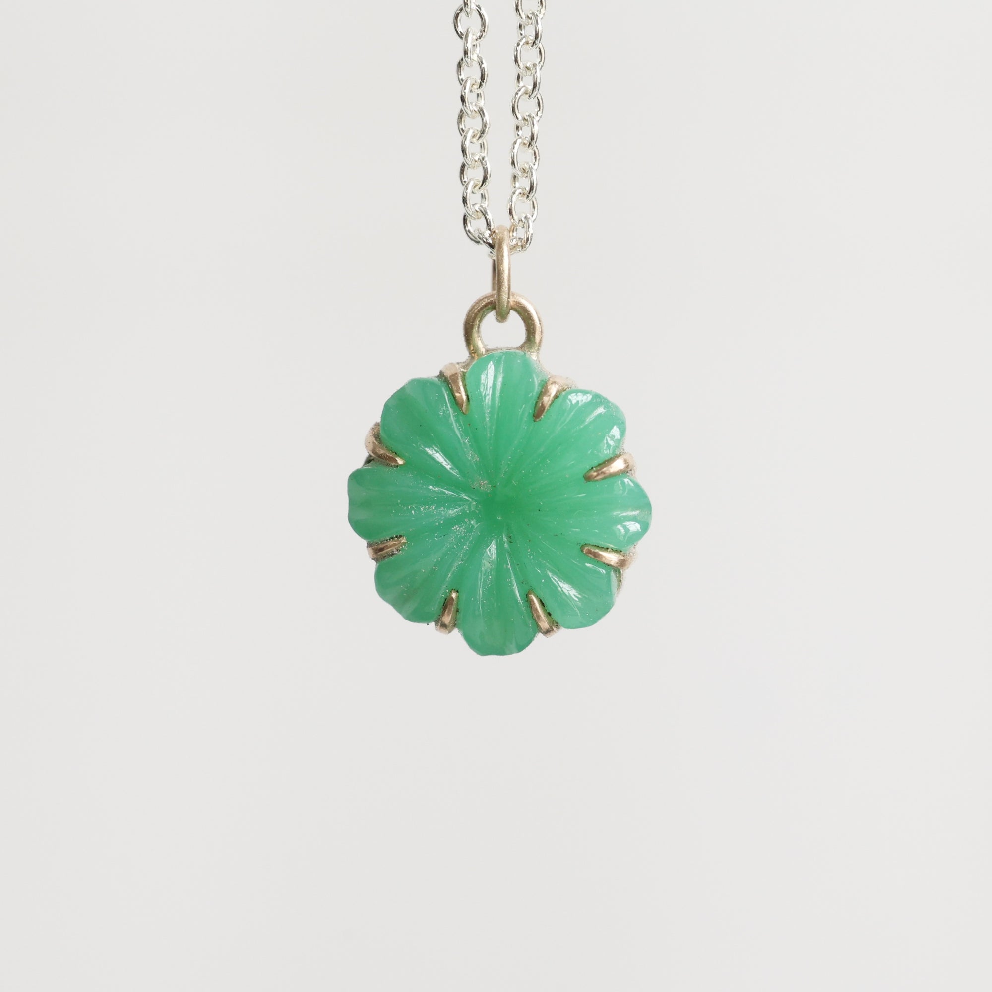 Green carved stone on necklace pendant 