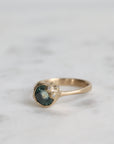 Gold ring with a gemstone on a marble surface