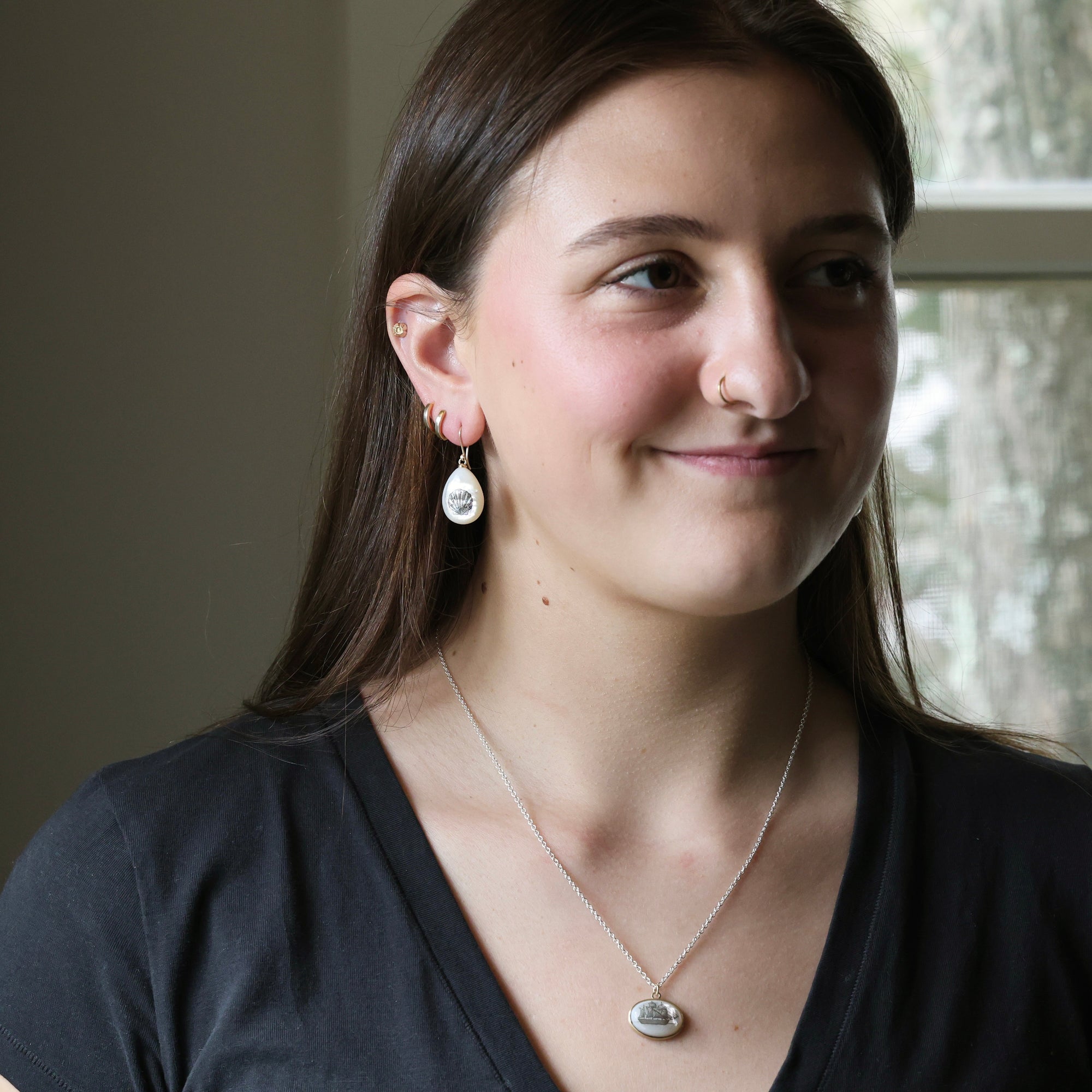 Woman wearing earrings and a necklace indoors