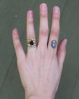Hand wearing lots of rings stacked 