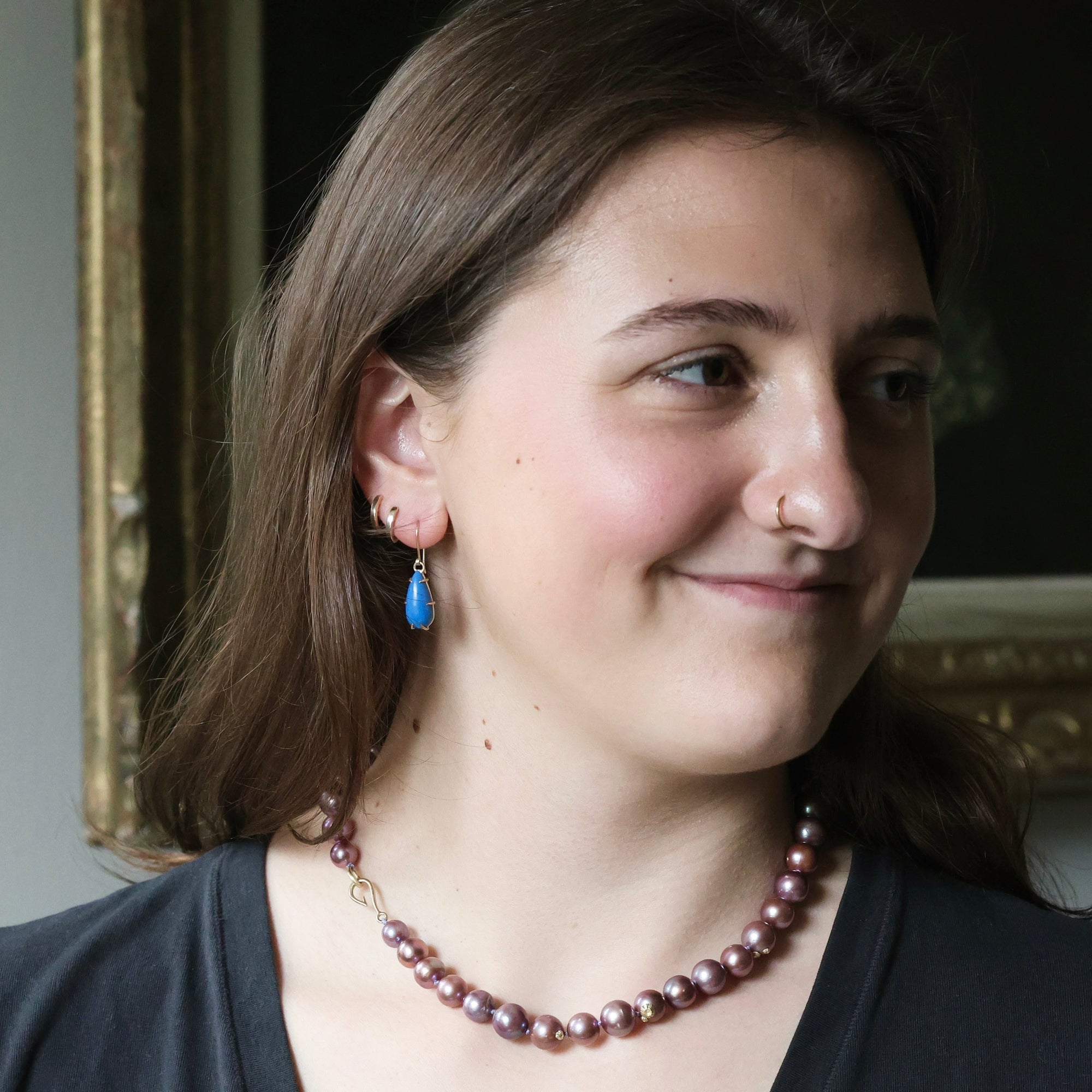 Woman wearing blue teardrop shaped earrings