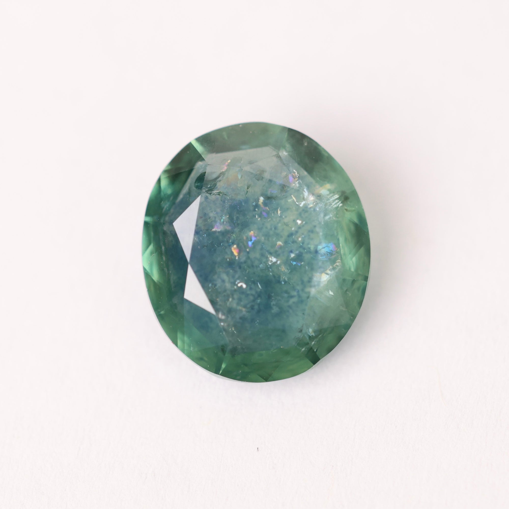 Green gemstone on a white background