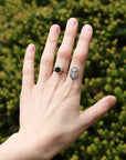 green gemstone ring with barnacles on hand
