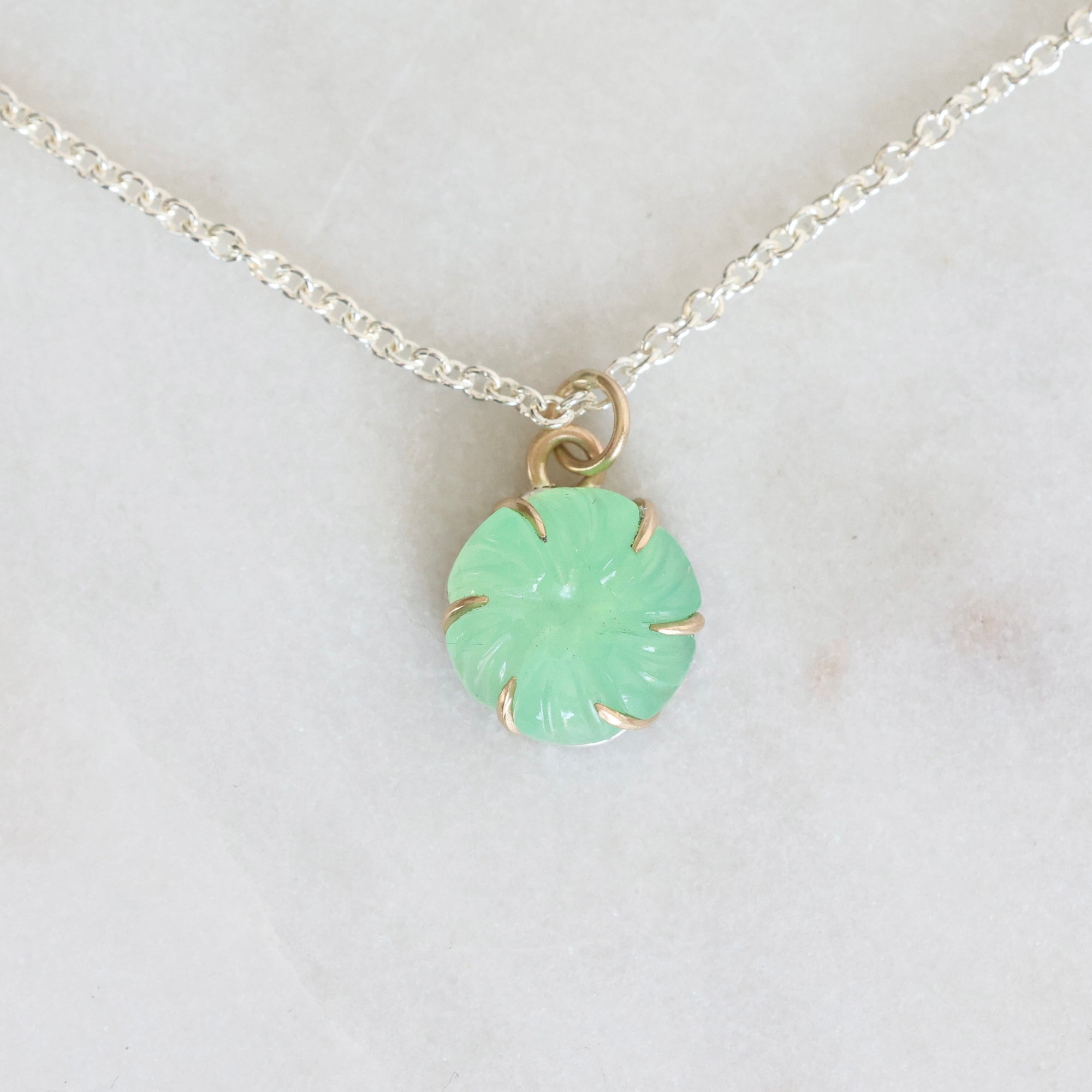 Necklace with a green pendant on a white background
