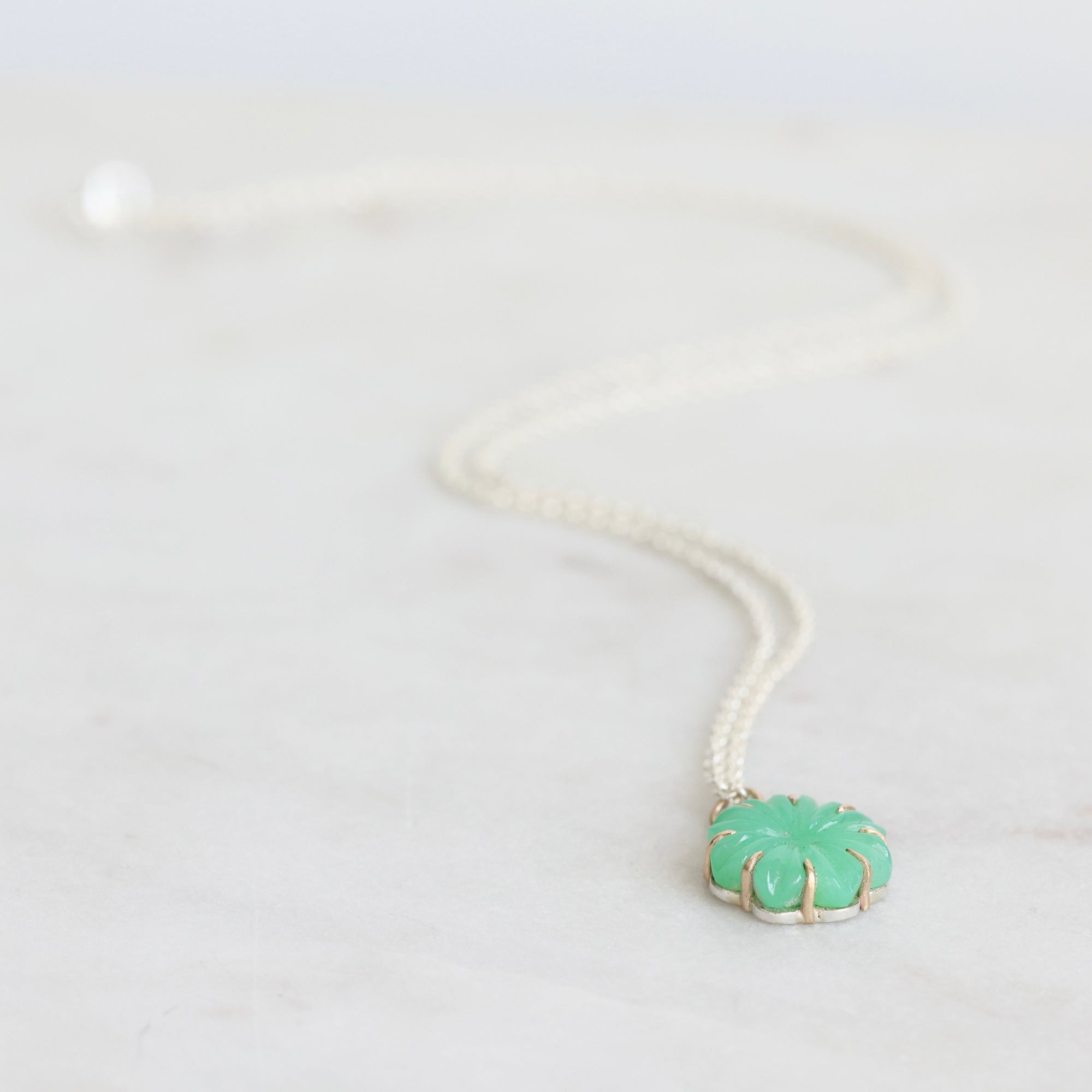 Green carved stone on necklace pendant 