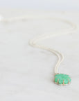 Green carved stone on necklace pendant 