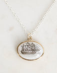 Necklace with a pendant featuring a ship design on a light background