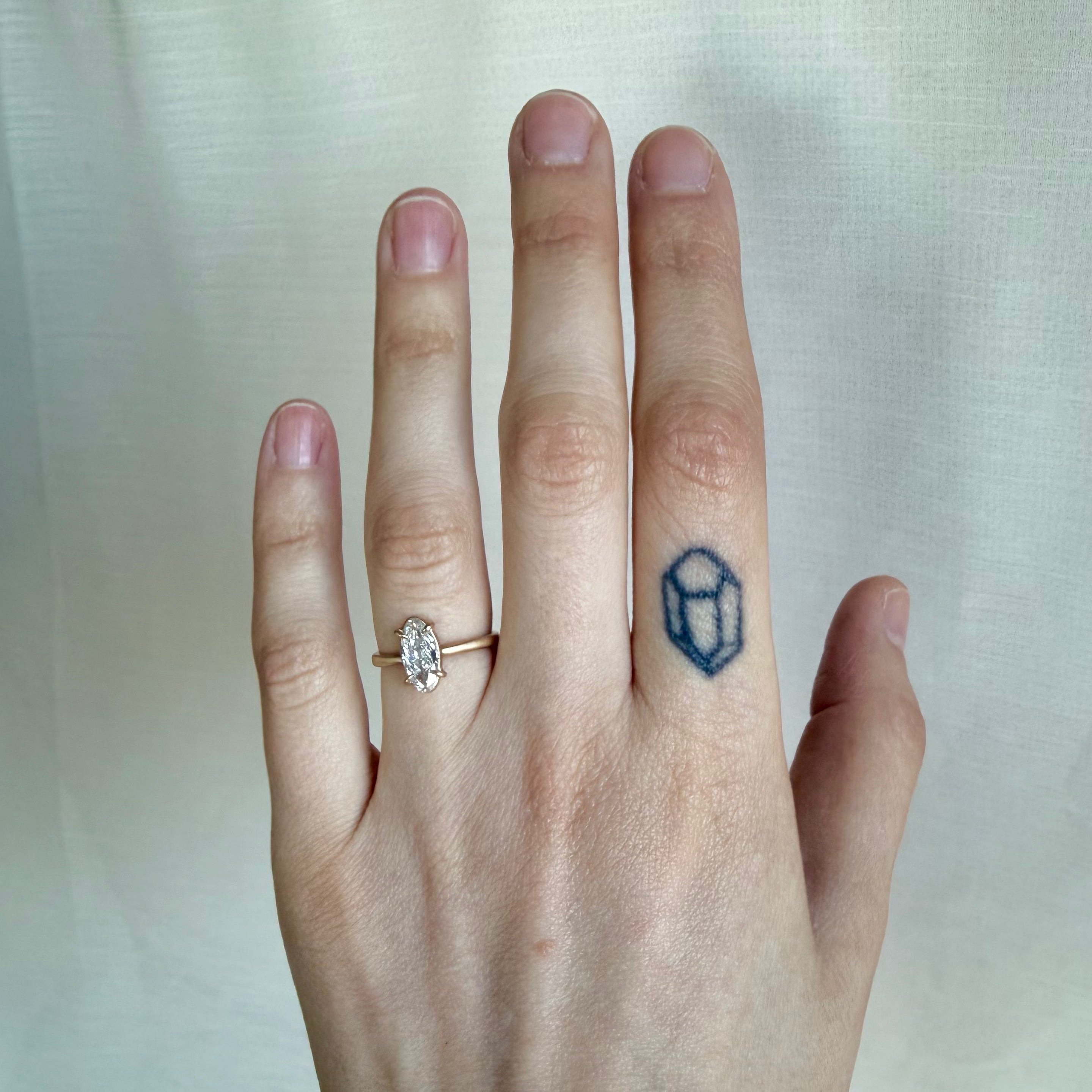 elongated oval diamond ring on a ahand