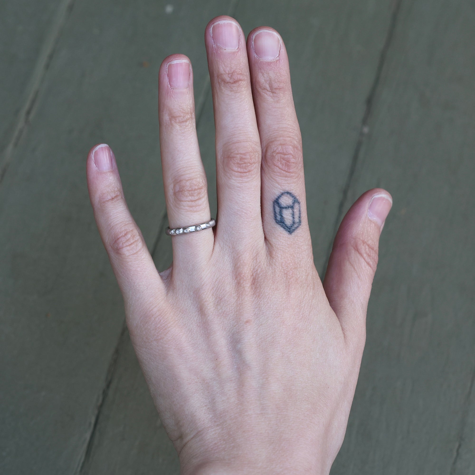 Hand wearing solid platinum barnacle band 
