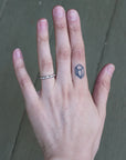 Hand wearing solid platinum barnacle band 