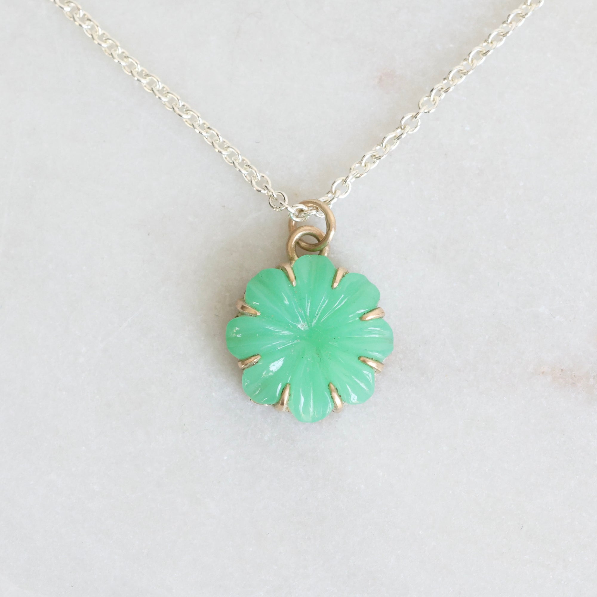 Green carved stone on necklace pendant 