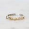 Silver ring with gold accents on a white background