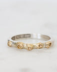 Silver ring with gold accents on a white background