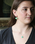Woman wearing green earrings 