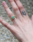 cured barnacle band with green gemstone ring 