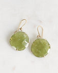 Pair of green stone earrings on a light background