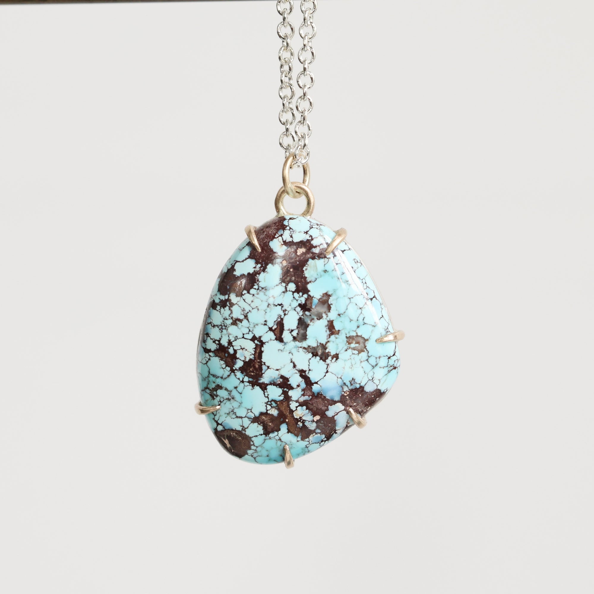 Turquoise stone necklace on a white background