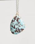 Turquoise stone necklace on a white background