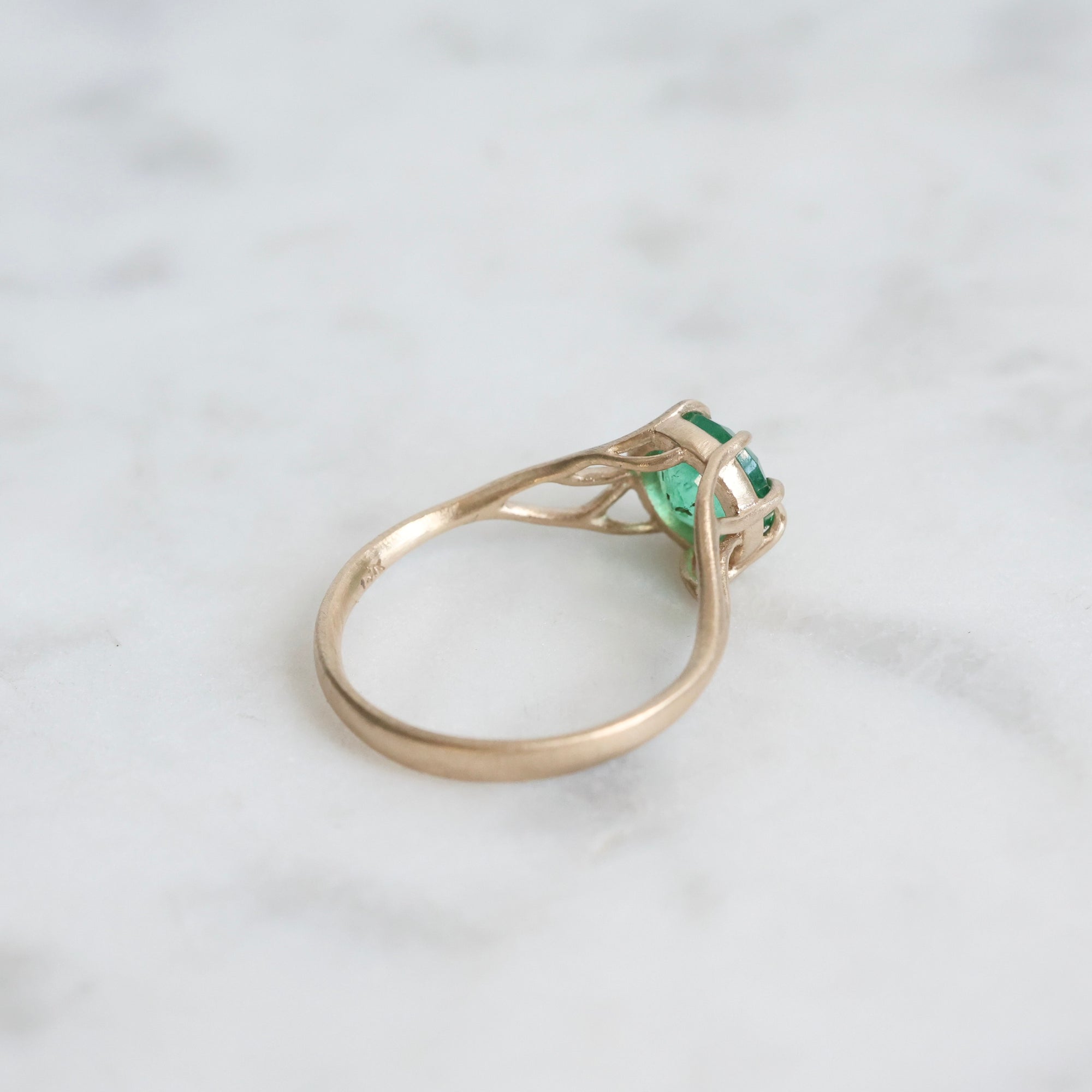 Green gemstone ring in gold branchy prongs