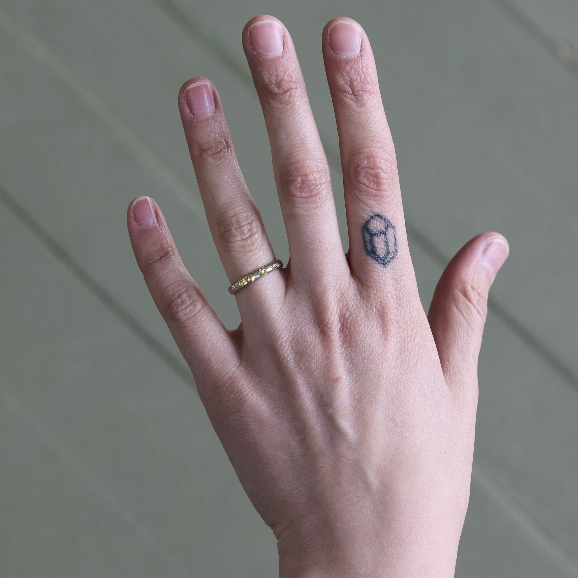 Hand wearing barnacle band 