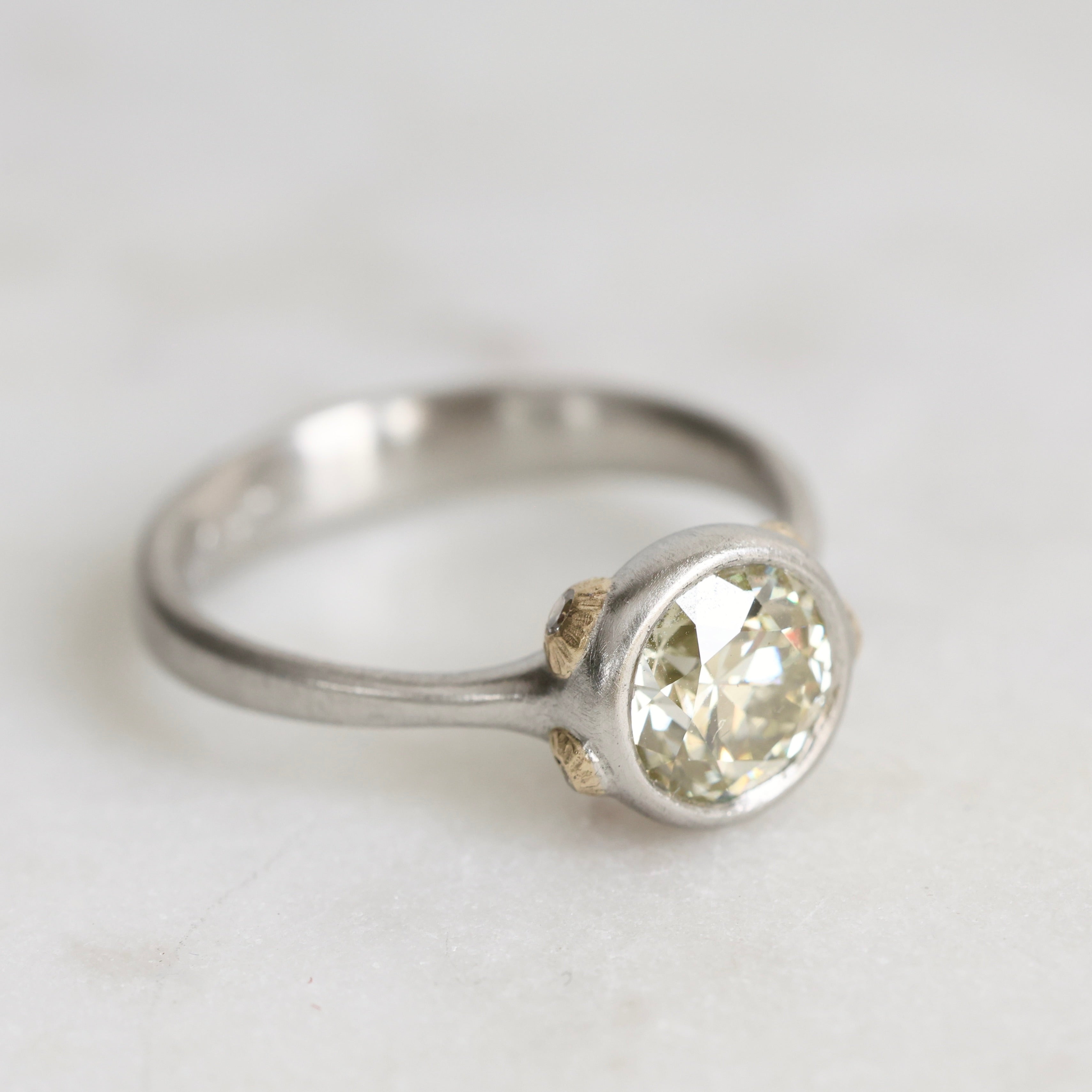 Platinum Ring with Gold Barnacles and a yellow diamond on a white background
