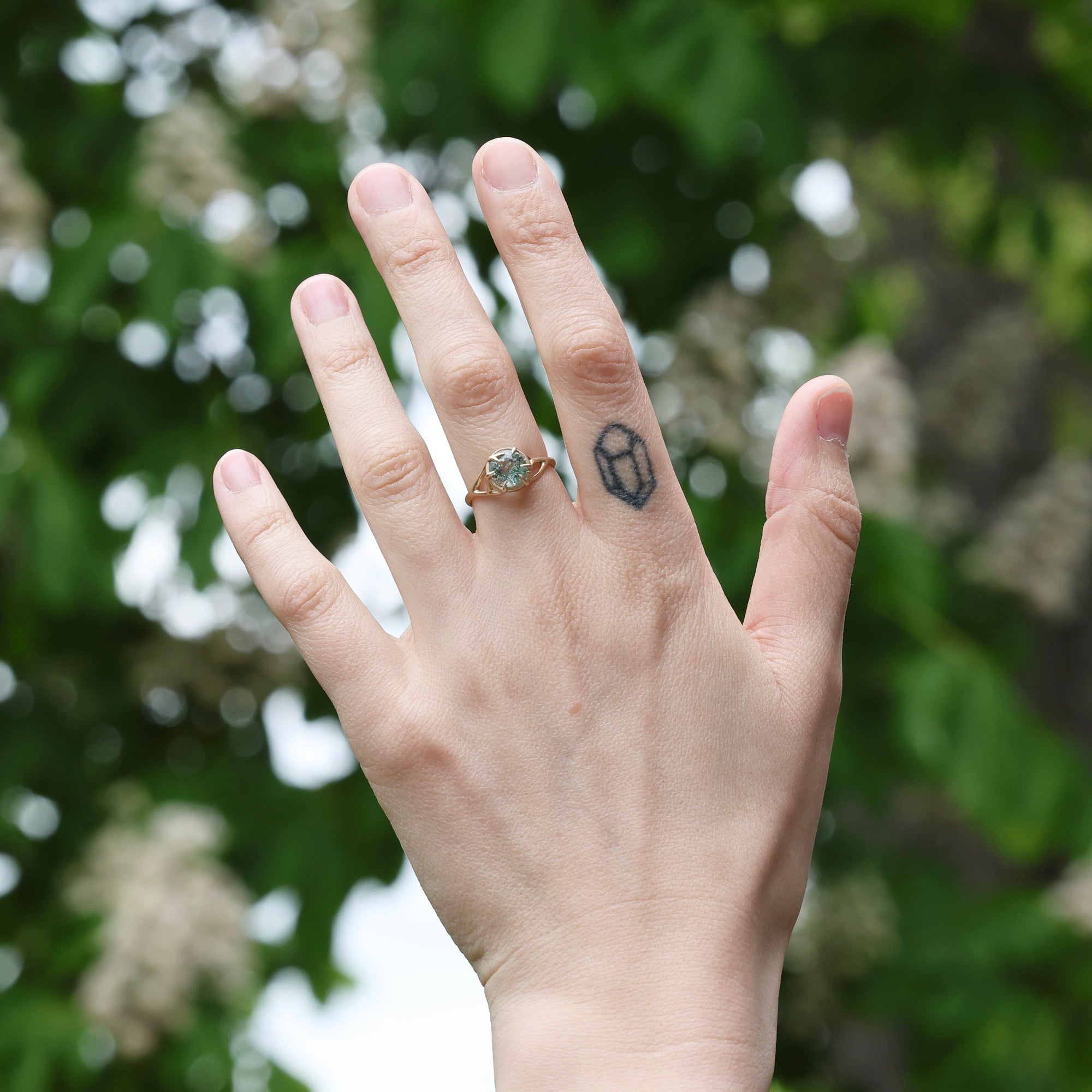 gold branch ring on hand