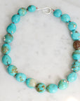 Turquoise Strand with silver barnacles and red thread