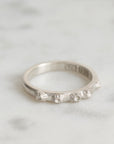 Silver ring with barnacle design on a light gray background