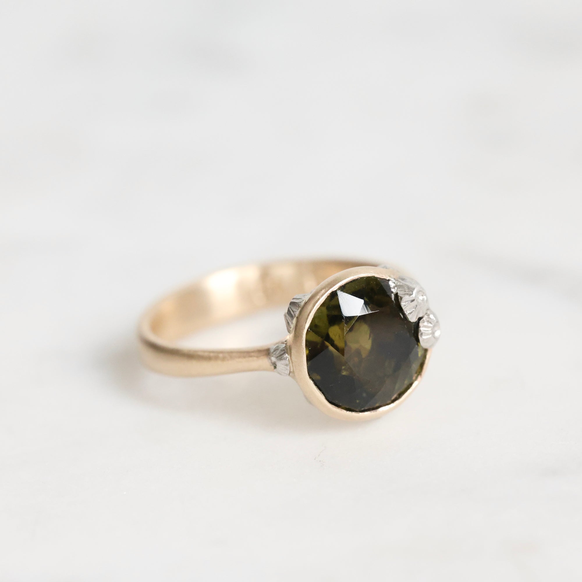 green gemstone ring with barnacles 