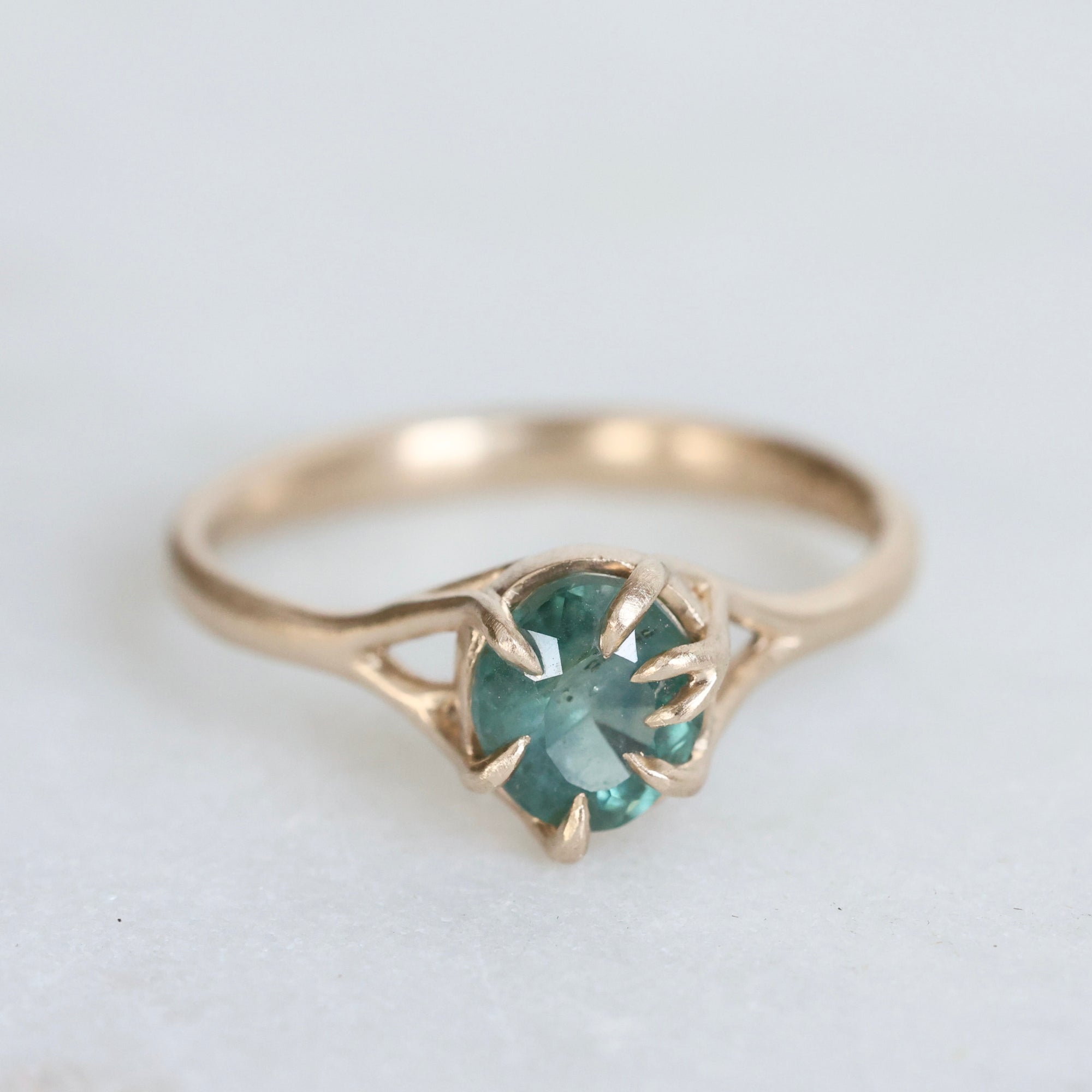 Green/blue sapphire in gold branchy setting