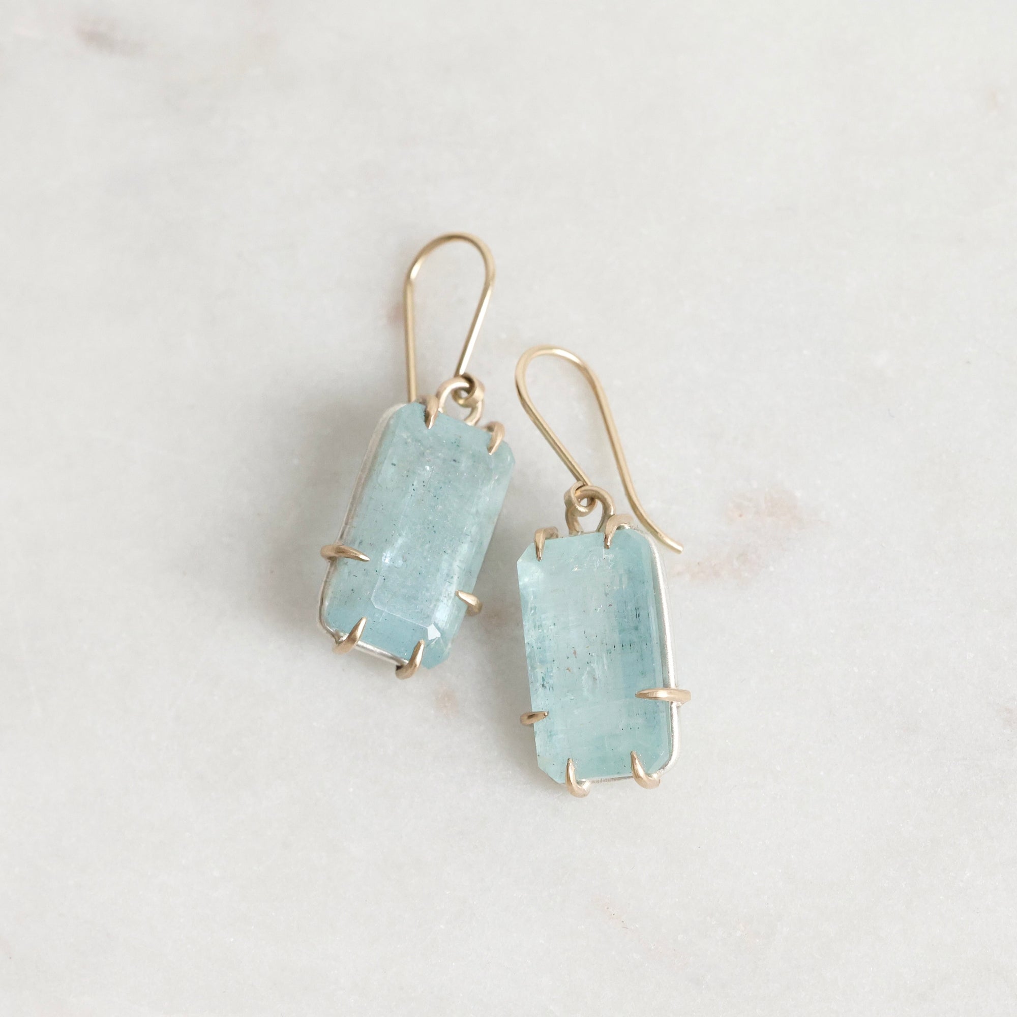 Bright blue stones suspended from gold ear wires