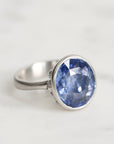 Silver ring with a blue gemstone on a white background