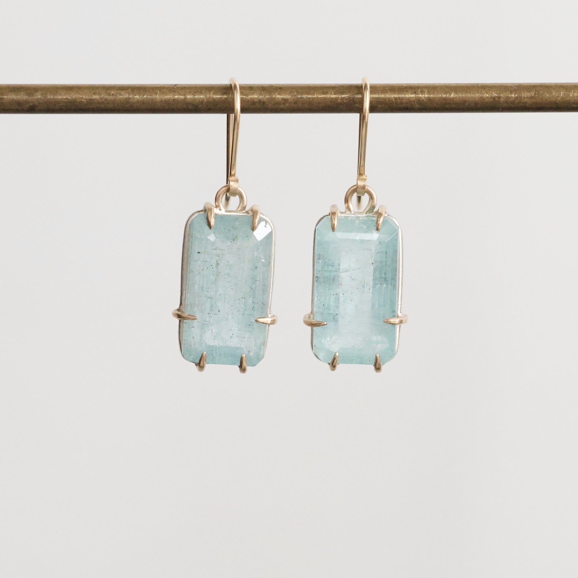 Bright blue stones suspended from gold ear wires