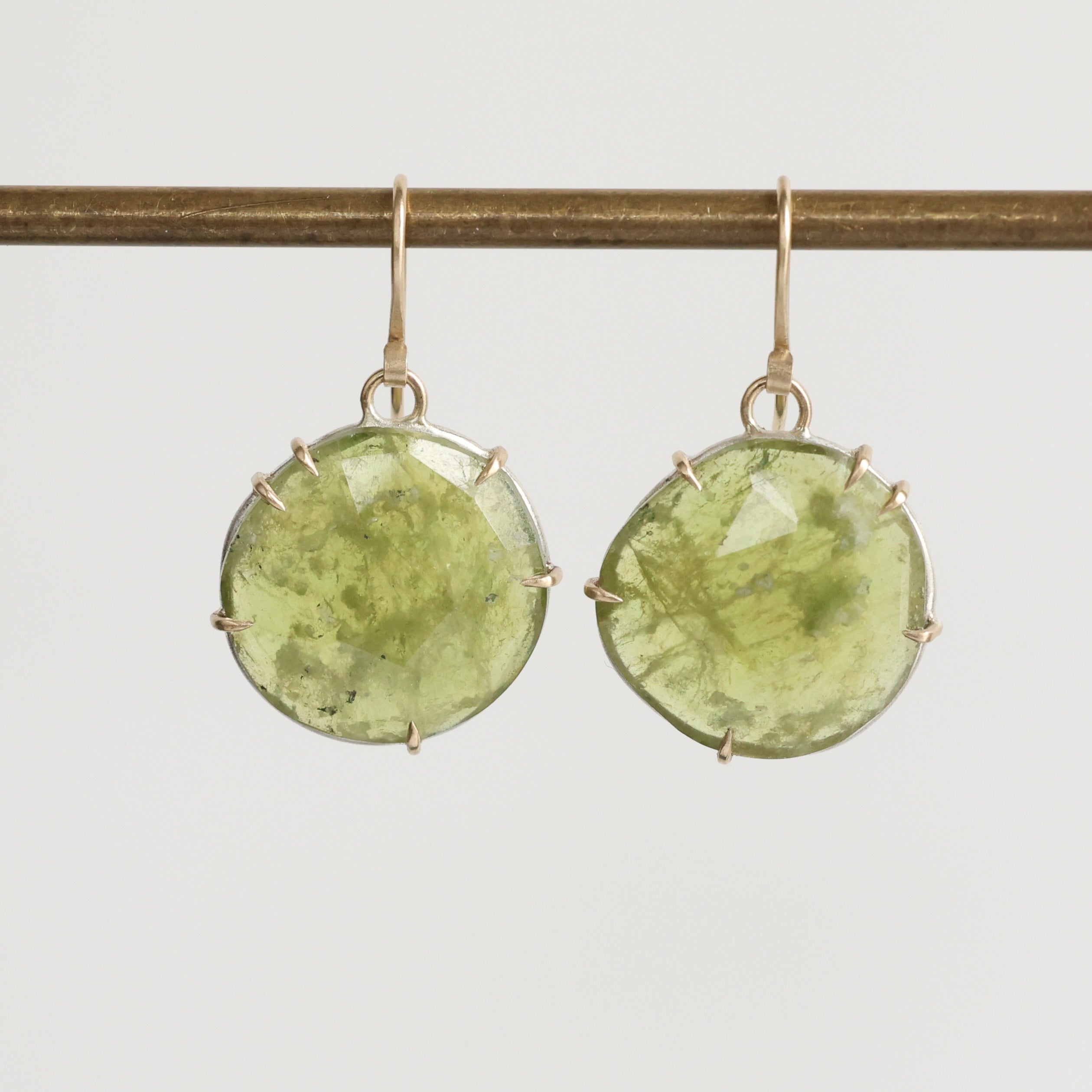 Green stone earrings on a white background